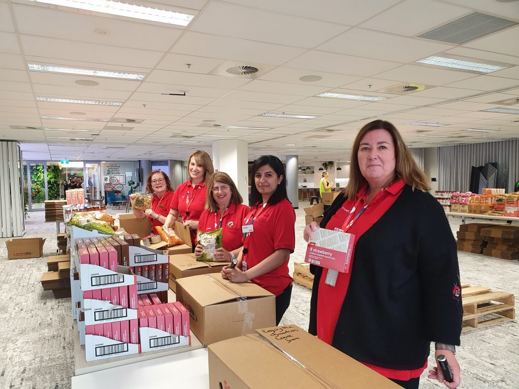 Coles team members packed hampers with essential pantry items to support our agencies.